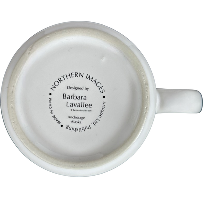 Bottom view of Barbara Lavallee Inuit family sledding mug showing design details and branding