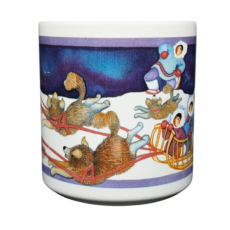 Barbara Lavallee Inuit family sledding mug featuring a colorful winter scene with sled dogs and family