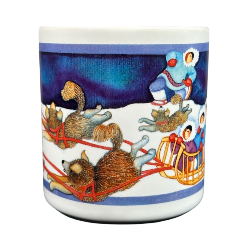 Barbara Lavallee Inuit family sledding mug featuring colorful sled dogs and family on a snowy background