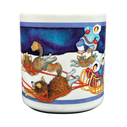 Barbara Lavallee Inuit family sledding mug featuring colorful sled dogs and family on a snowy background