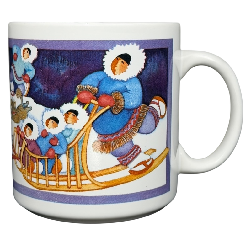Barbara Lavallee Inuit family sledding mug featuring vibrant artwork of an Inuit family and sledding scene