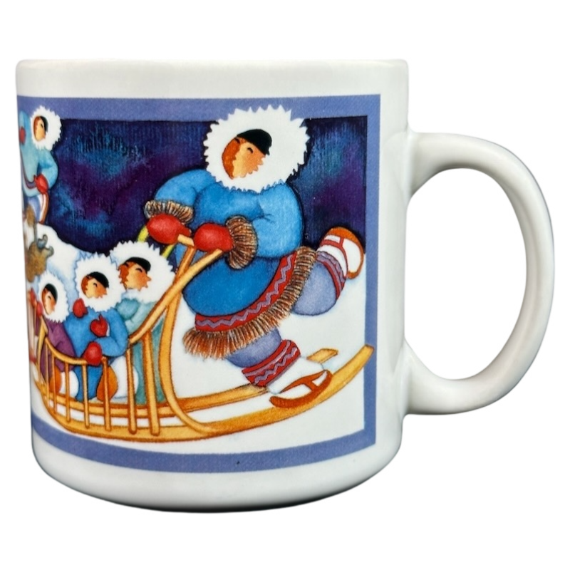 Barbara Lavallee Inuit family sledding mug featuring colorful artwork of an Inuit family on a sled