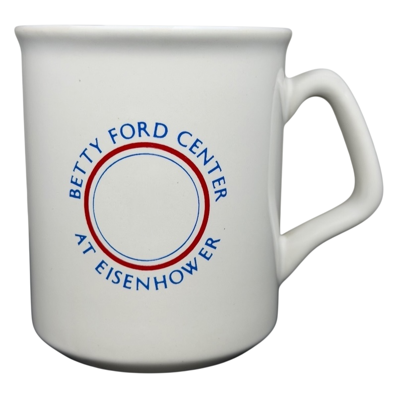 Ceramic mug featuring the Betty Ford Center At Eisenhower logo in blue and red design