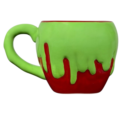 Snow White Evil Queen Green Poison Apple Mug Bioworld Disney with a dripping design featuring green and red colors