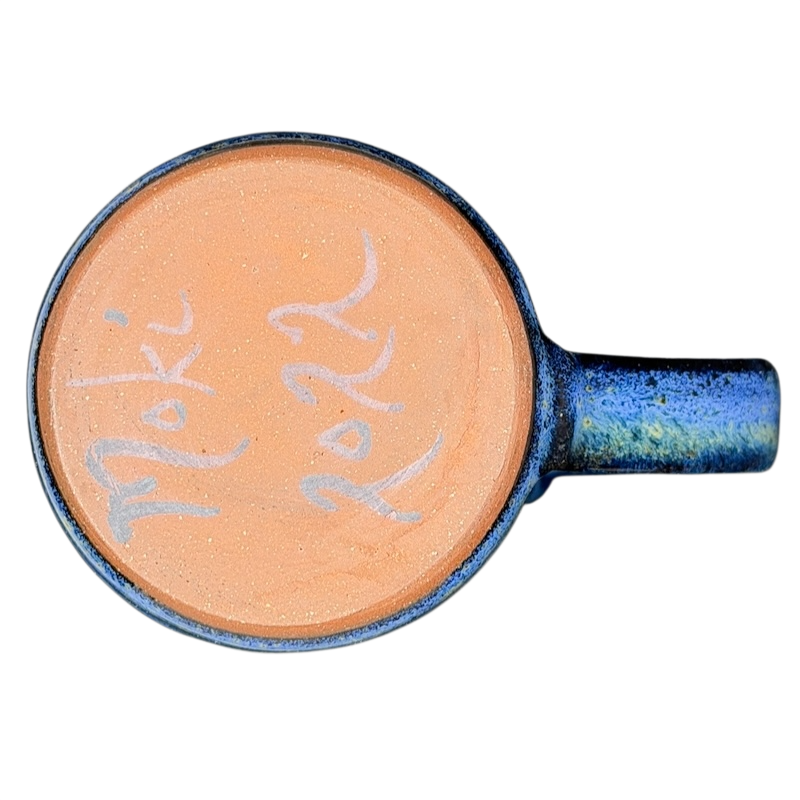Bottom view of a Blue Speckled Gecko Pottery Mug showcasing its unique orange interior and artistic design