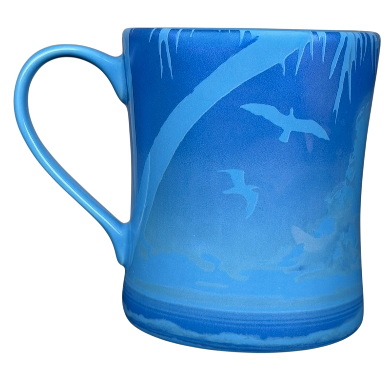 Bubba Gump Shrimp Co The Office mug in blue featuring a serene beach scene and birds in flight