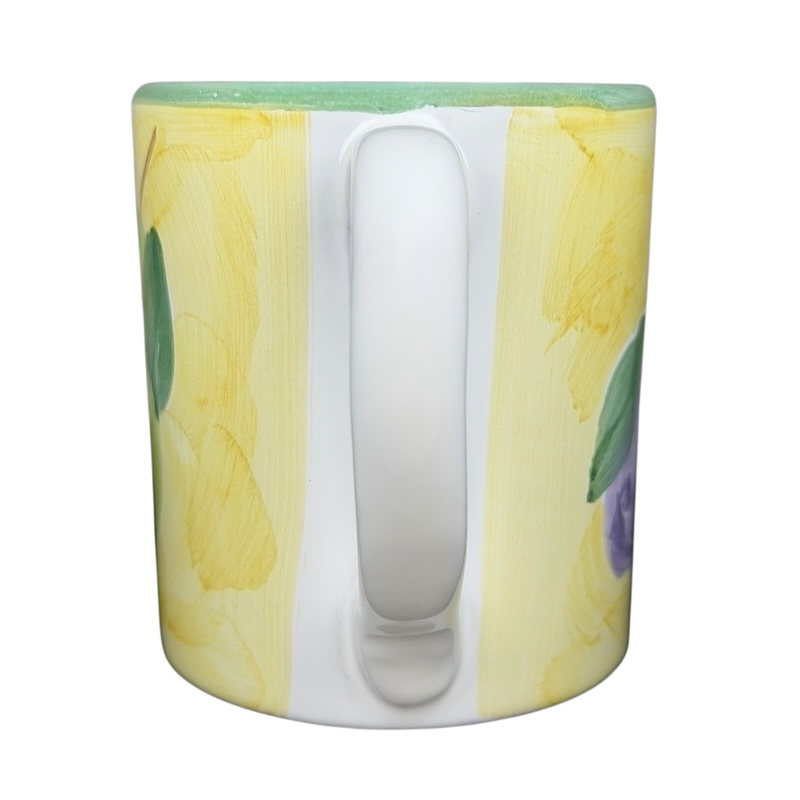 Caleca Frutta Pear and Plums mug featuring colorful fruit illustrations on a vibrant background