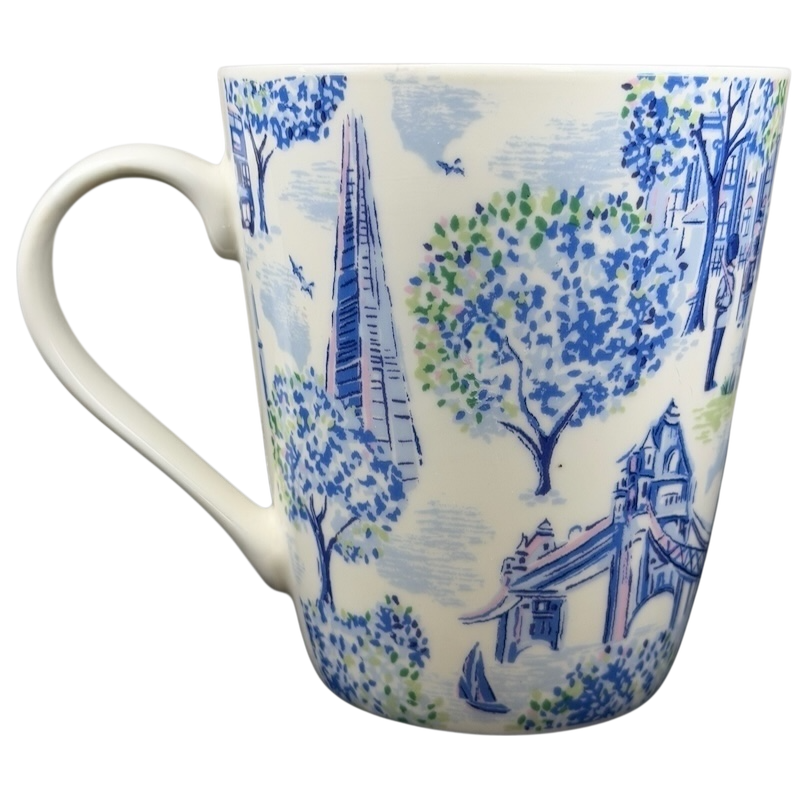 Cath Kidston London mug featuring vibrant blue designs of trees and iconic city landmarks