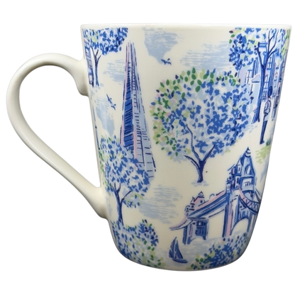 Cath Kidston London mug featuring vibrant blue designs of trees and iconic city landmarks