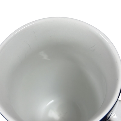 Close up top view of empty white ceramic Coventry Pisces astrology collectible mug interior with light scratches