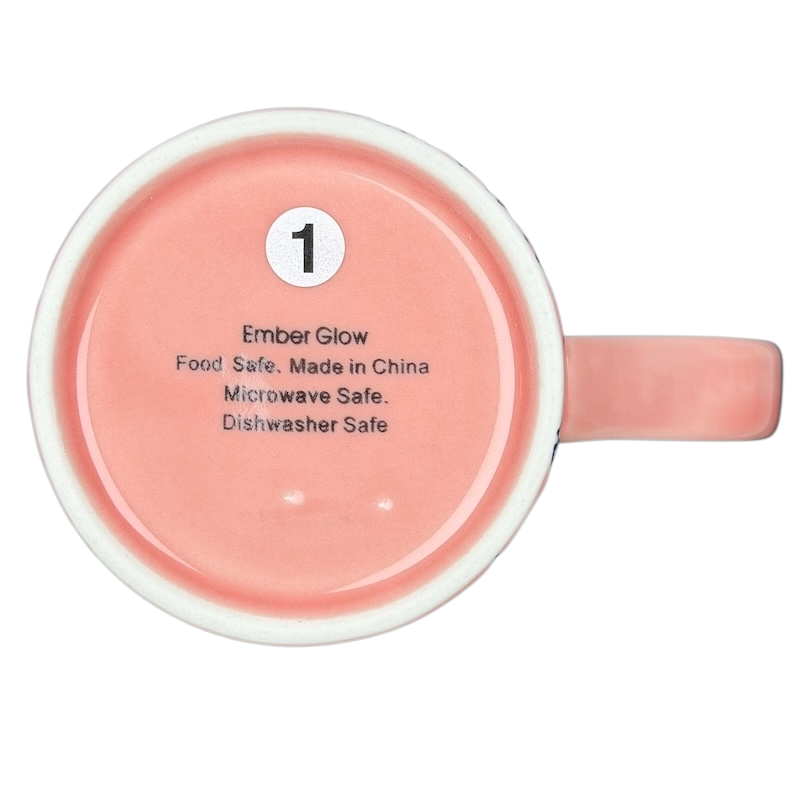 Underside view of Cute Pink Cat Orange Scarf Ember Glow Mug with safety details and care instructions