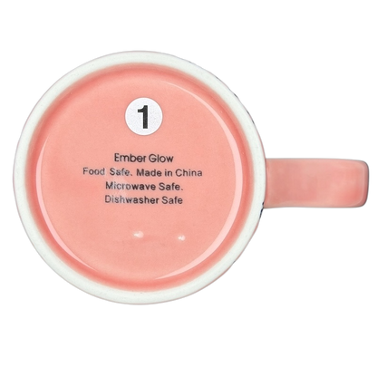 Underside view of Cute Pink Cat Orange Scarf Ember Glow Mug with safety details and care instructions