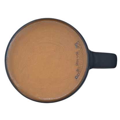 Top view of Grand Canyon National Park Deneen Pottery collectible mug with unglazed terracotta base and blue handle