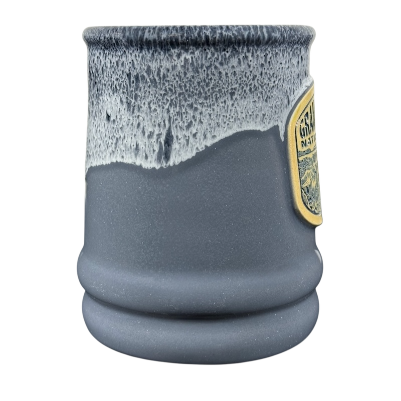 Grand Canyon National Park Deneen Pottery collectible mug. Gray stoneware with white drip glaze and embossed park badge