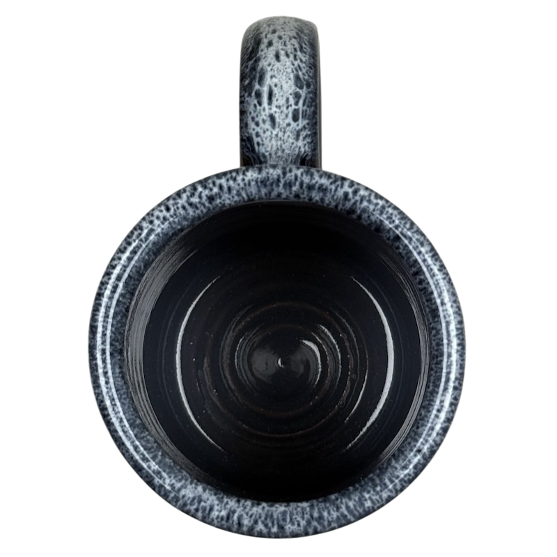 Top view of black ceramic mug with gray speckled rim and handle Grand Canyon National Park Deneen Pottery collectible mug.