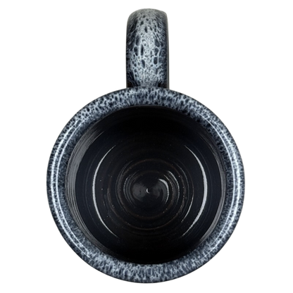 Top view of black ceramic mug with gray speckled rim and handle Grand Canyon National Park Deneen Pottery collectible mug.