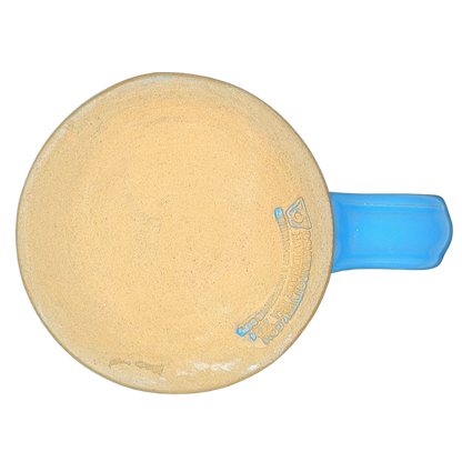 Top view of a Mount Rainier National Park Mug Deneen Pottery with a blue handle and unglazed interior