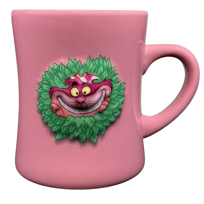 Alice In Wonderland Cheshire Cat Mug Disney in pink with a vibrant cat design on a leafy backdrop