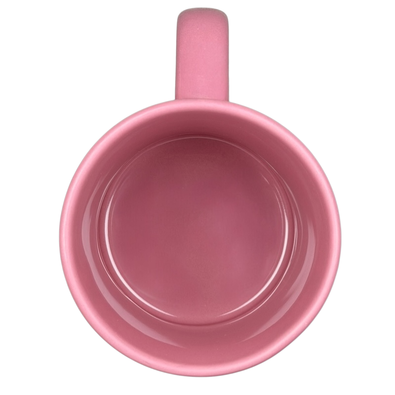 Top view of a pink ceramic Alice In Wonderland Cheshire Cat Mug Disney with a smooth interior finish
