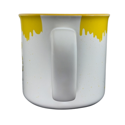 Disney collectible Winnie the Pooh mug with yellow dripping honey design and white handle