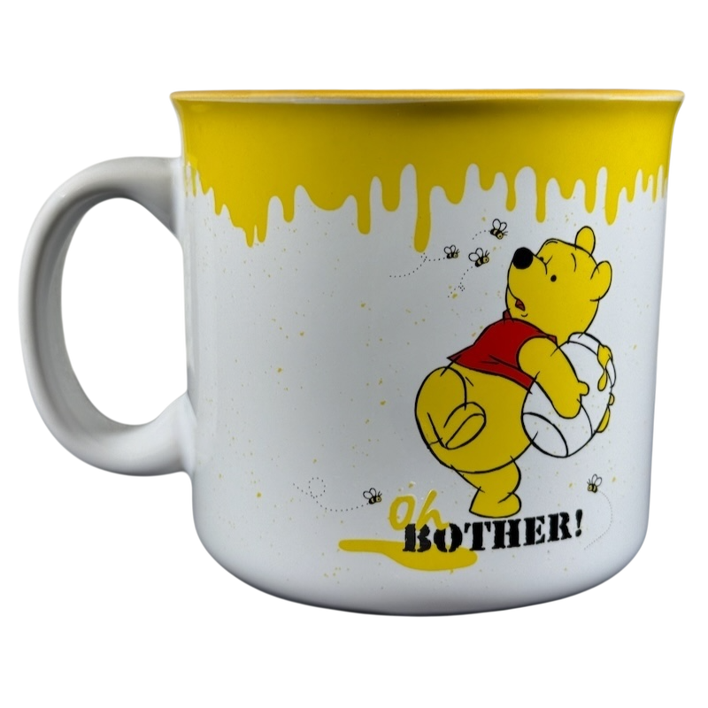 Disney collectible Winnie the Pooh mug with yellow honey drip design and Oh Bother text