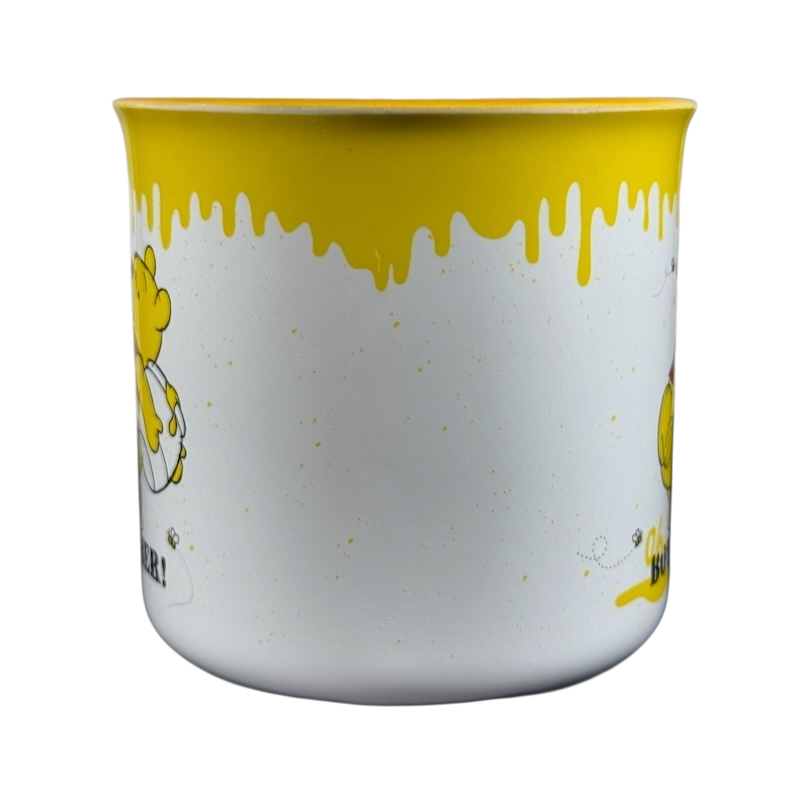 Disney collectible Winnie the Pooh mug with yellow honey drip design and Pooh character on white background