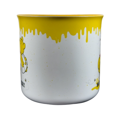 Disney collectible Winnie the Pooh mug with yellow honey drip design and Pooh character on white background