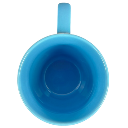 Top view of bright blue ceramic Disney Pixar Up Dug collectible mug showing interior and handle on black background
