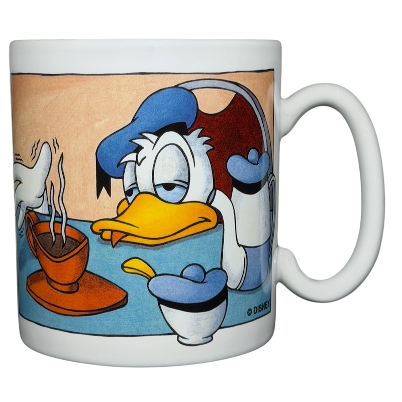 Donald Duck morning mood jumbo mug featuring Donald looking sleepy next to a steaming cup