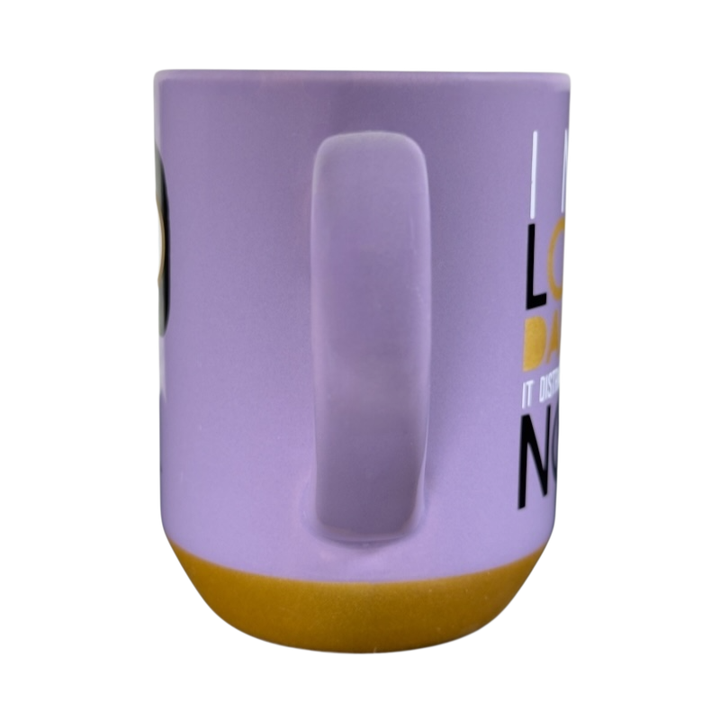 Side view of purple and mustard Disney Edna Mode Disney mug with handle on black background