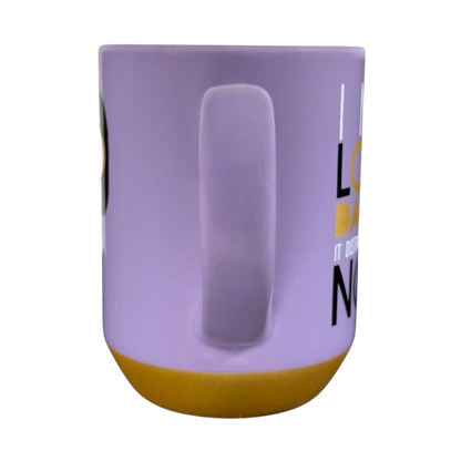 Side view of purple and mustard Disney Edna Mode Disney mug with handle on black background