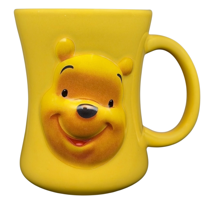 Disney Huggably Pooh embossed mug in bright yellow featuring Winnie the Pooh's smiling face