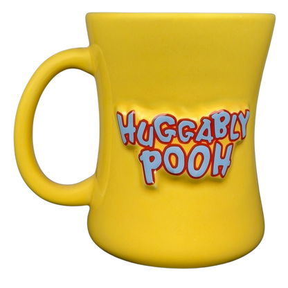 Bright yellow Disney Huggably Pooh embossed mug featuring playful text design