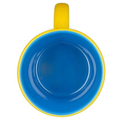 Disney Huggably Pooh embossed mug featuring a bright yellow exterior and blue interior design