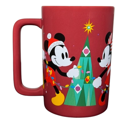 Disney Mickey and Friends holiday mug featuring Mickey and Minnie decorating a Christmas tree