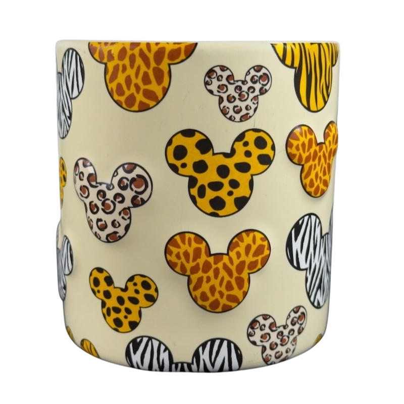 Disney Mickey Mouse vintage Animal Kingdom mug featuring animal print Mickey heads on cream background