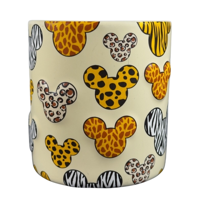 Disney Mickey Mouse vintage Animal Kingdom mug featuring animal print Mickey heads on cream background