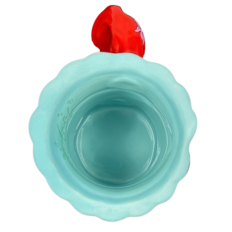 Top view of ceramic turquoise scalloped mug with red Ariel handle Ariel The Little Mermaid Disney Parks vintage mug