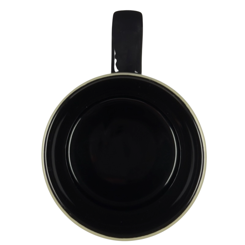 Top view of Grumpy Disney vintage collectible mug showing black interior cream rim and single handle