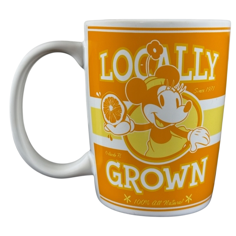 Disney Parks locally grown vintage mug featuring Minnie Mouse holding an orange slice in orange and yellow design