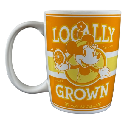 Disney Parks locally grown vintage mug featuring Minnie Mouse holding an orange slice in orange and yellow design