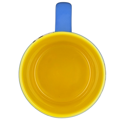 Top view of Mickey Mouse collectible Glitter Mug Disney Parks in bright yellow and blue colors
