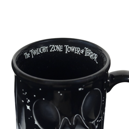 Close up black ceramic Twilight Zone Tower of Terror Disney collectible mug with inner rim lettering and starry design