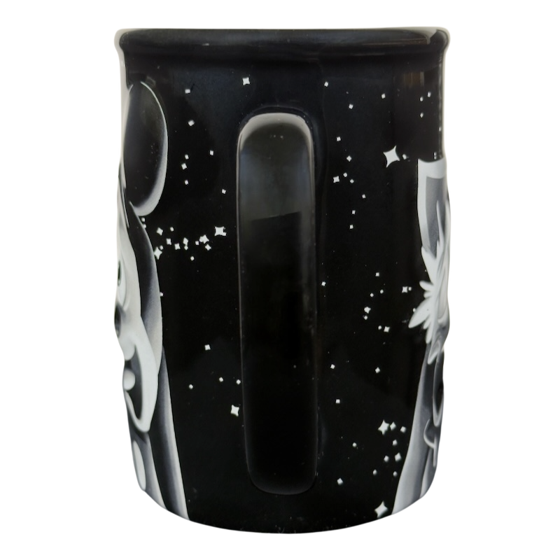 Twilight Zone Tower of Terror Disney collectible mug black ceramic with starry background and white ghosts and handle visible