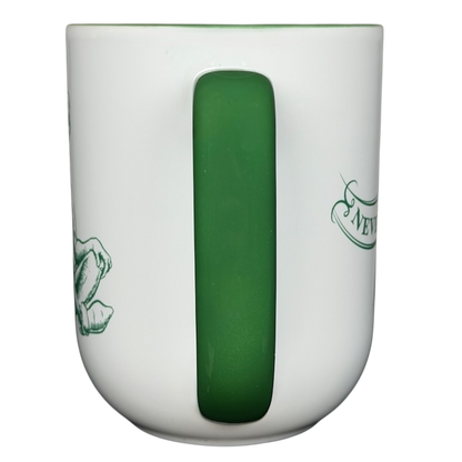 Peter Pan Never Grow Up Disney mug featuring a green handle and whimsical designs