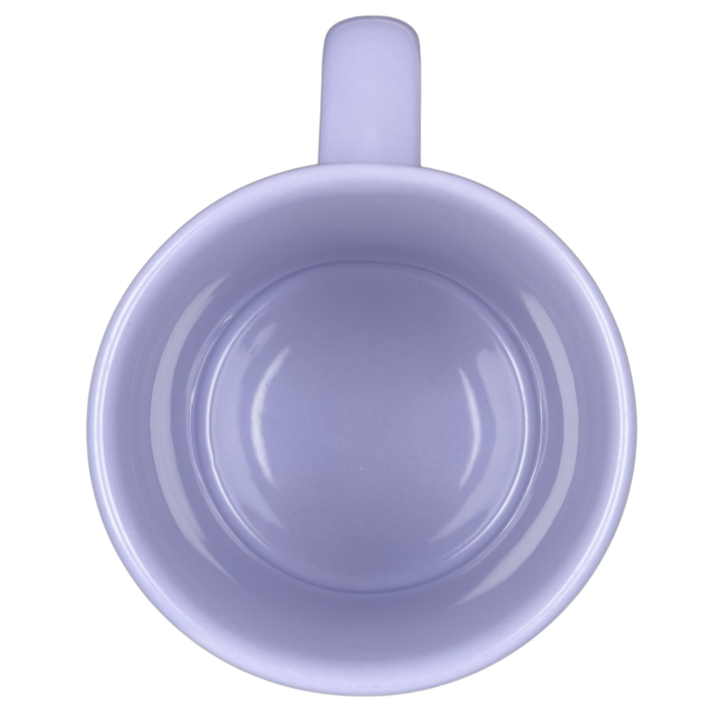 Top view of empty lavender Disney Tinker Bell stuck in keyhole vintage mug on black background