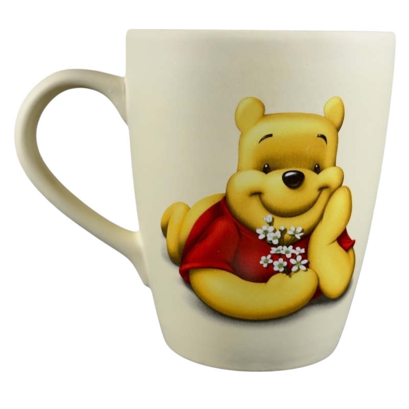 Disney vintage Winnie the Pooh flowers coffee cup featuring Pooh holding white flowers and smiling