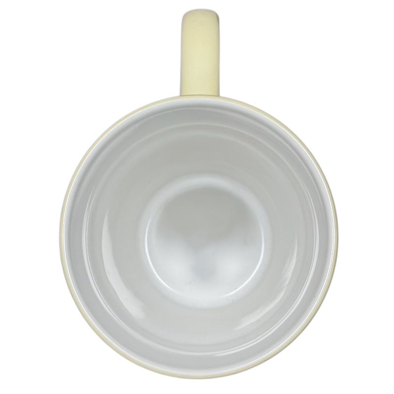 Top view of vintage Winnie the Pooh flowers coffee cup with cream-colored handle and white interior