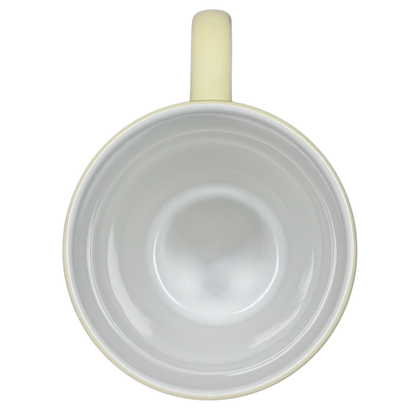 Top view of vintage Winnie the Pooh flowers coffee cup with cream-colored handle and white interior