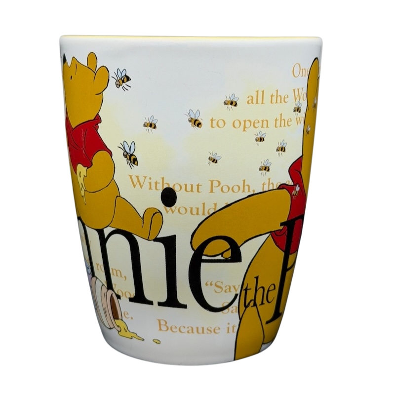 Winnie the Pooh Storybook Mug Disney Store featuring Pooh and bees with a quote background